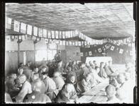 村の集会（天井に万国旗）